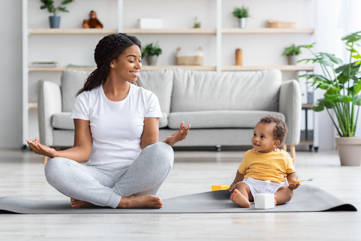 Trainings with Baby. Black Mother and Toddler Son Practicing Yoga at Home