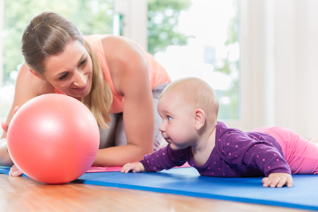 Mom and Her Baby Practicing to Crawl